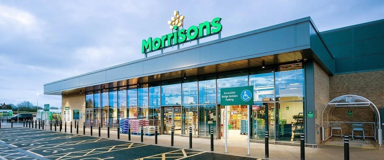 Morrisons is rolling out AI-powered self-checkouts across 200 stores, using real-time computer vision to spot missed items and prompt shoppers to self-correct.