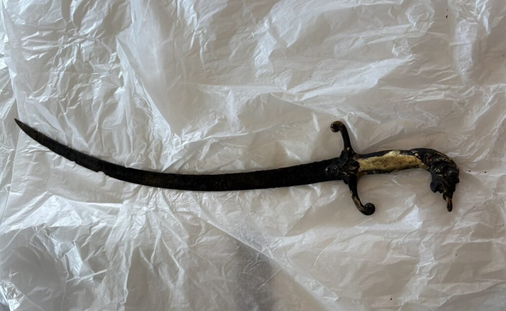 An 'Excalibur' style sword has been found sticking out of a castle lake after hot weather caused the water levels to plummet, revealing the hidden blade.