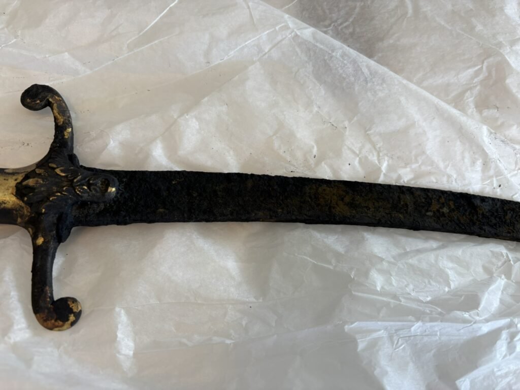 An 'Excalibur' style sword has been found sticking out of a castle lake after hot weather caused the water levels to plummet, revealing the hidden blade.