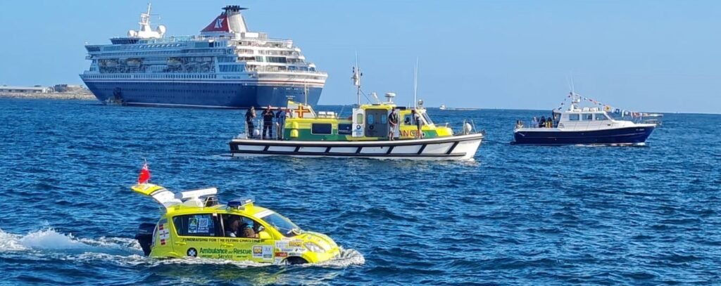 An amphibious ambulance car has sailed nine miles across the sea from Guernsey to Sark - taking three hours to complete the bizarre charity voyage.
