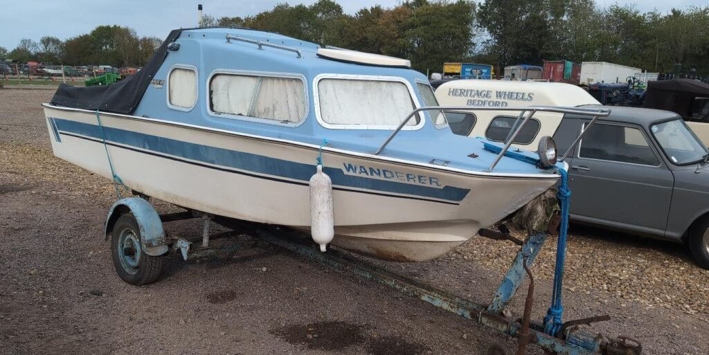 A hoard of more than 150 classic cars, tractors and boats unseen for decades has been found hidden across six Bedfordshire barns - and could fetch £250,000 at auction.