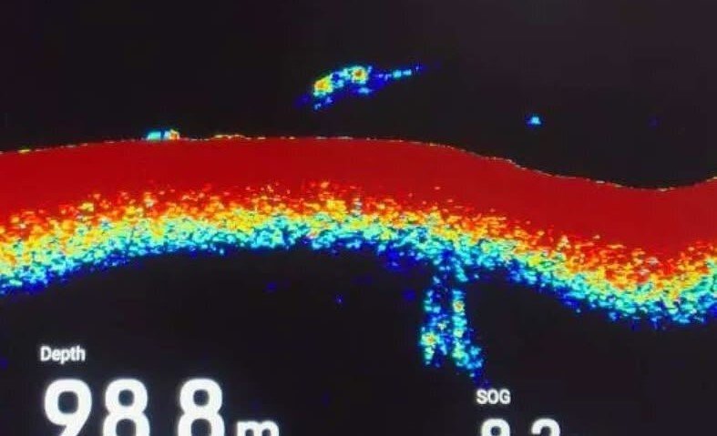 Nessie hunters have captured mysterious footage of a large black hump speeding across Loch Ness just before midnight - in a first for nocturnal searches.