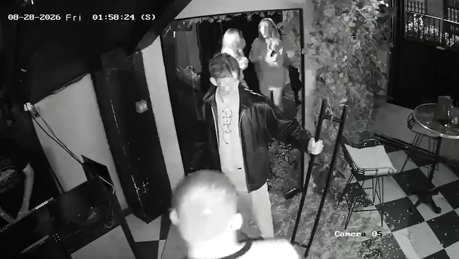 Watch the moment a man yanks open a bar door - only for the glass to explode into shards, leaving him frozen in the doorway still gripping the handle.