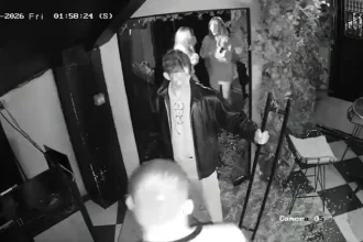 Watch the moment a man yanks open a bar door - only for the glass to explode into shards, leaving him frozen in the doorway still gripping the handle.