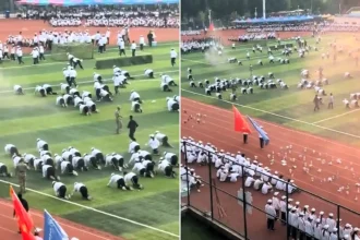 This is the bizarre moment students crawl on their knees through clouds of red smoke during a Squid Game-style military training drill at a Chinese college.