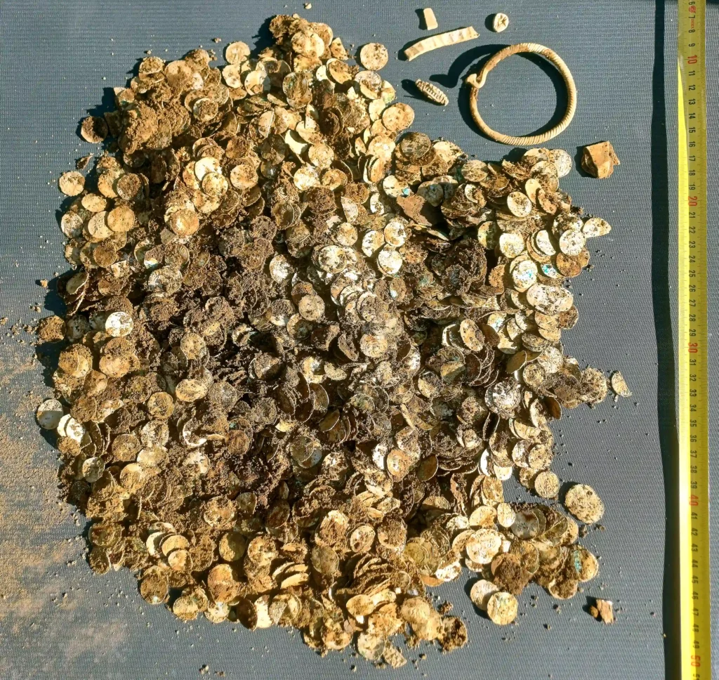 A treasure hunter who was about to give up has unearthed Finland's biggest ever Viking-era hoard - thousands of silver coins stashed in two birch-bark pots.
