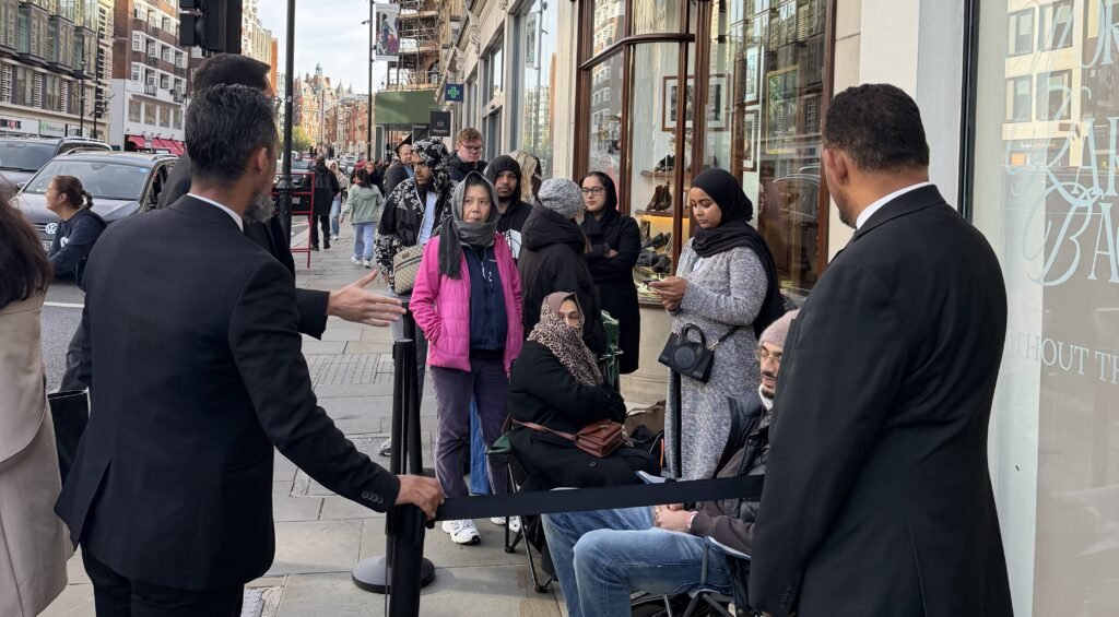A devoted husband queued for 12 hours so his wife could snap up a discounted Chanel bag at a Knightsbridge flash sale - as over 2,000 shoppers caused chaos outside.