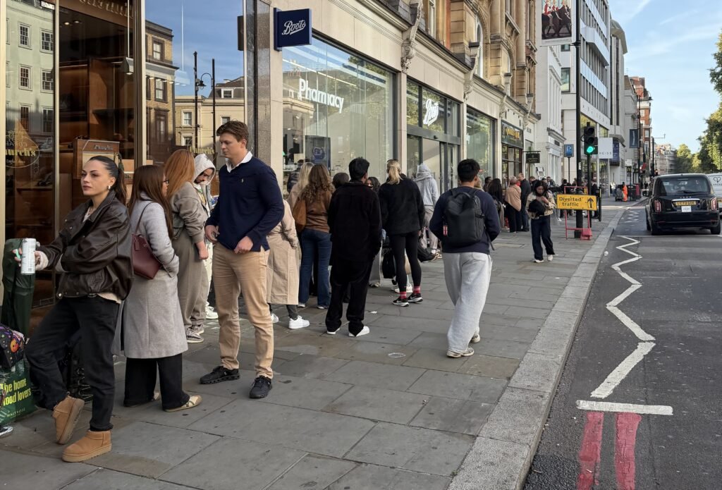 A devoted husband queued for 12 hours so his wife could snap up a discounted Chanel bag at a Knightsbridge flash sale - as over 2,000 shoppers caused chaos outside.