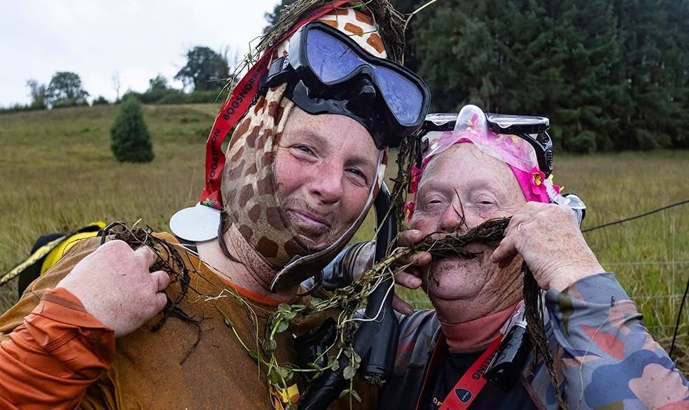 Daredevils dived headfirst into a filthy 120-yard bog as the World Bog Snorkelling Championships hit 40 years - with Emily Hall crowned champ in just 1:27.97.