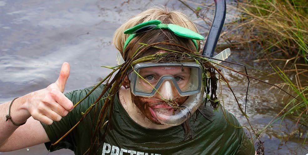 Daredevils dived headfirst into a filthy 120-yard bog as the World Bog Snorkelling Championships hit 40 years - with Emily Hall crowned champ in just 1:27.97.