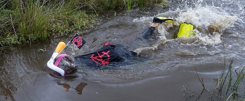 Daredevils dived headfirst into a filthy 120-yard bog as the World Bog Snorkelling Championships hit 40 years - with Emily Hall crowned champ in just 1:27.97.