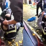 A cop's wig flew clean off while he wrestled a drunk suspect in South Korea - before a kind passerby calmly popped it back on his bald head without saying a word.