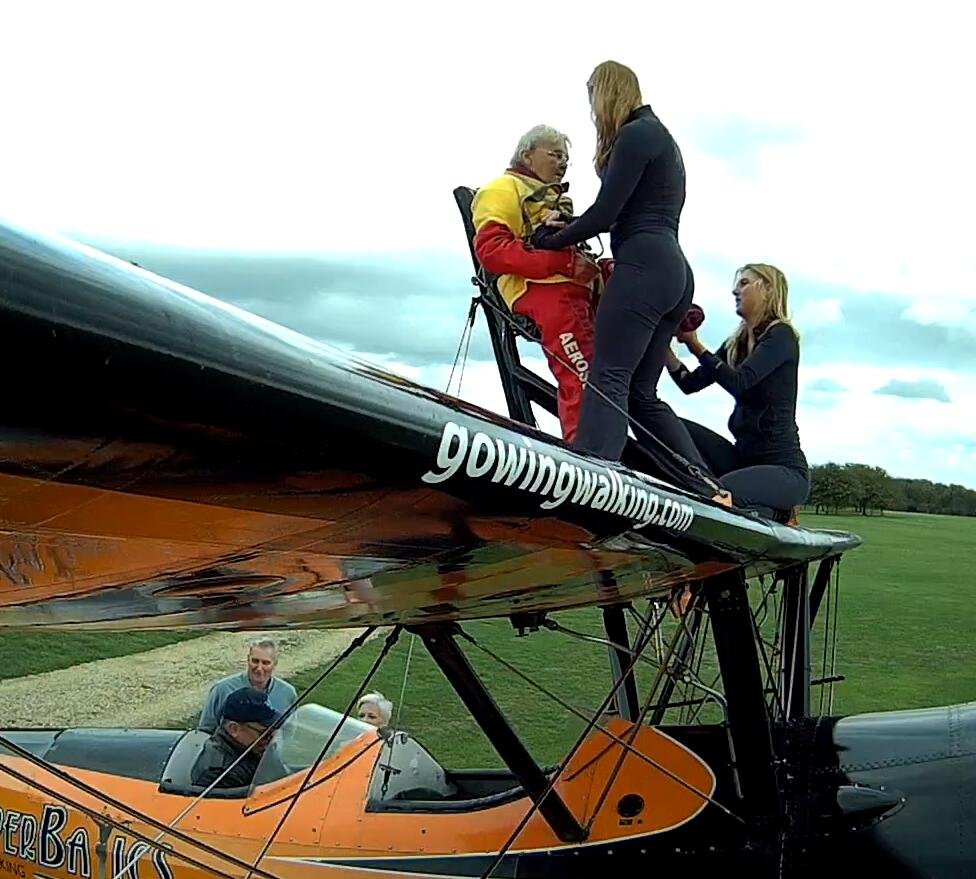 99-year-old Helga Duffy becomes world's oldest wing walker after strapping herself to plane. Inspired by another pensioner, she raised over £1,300 for charity.