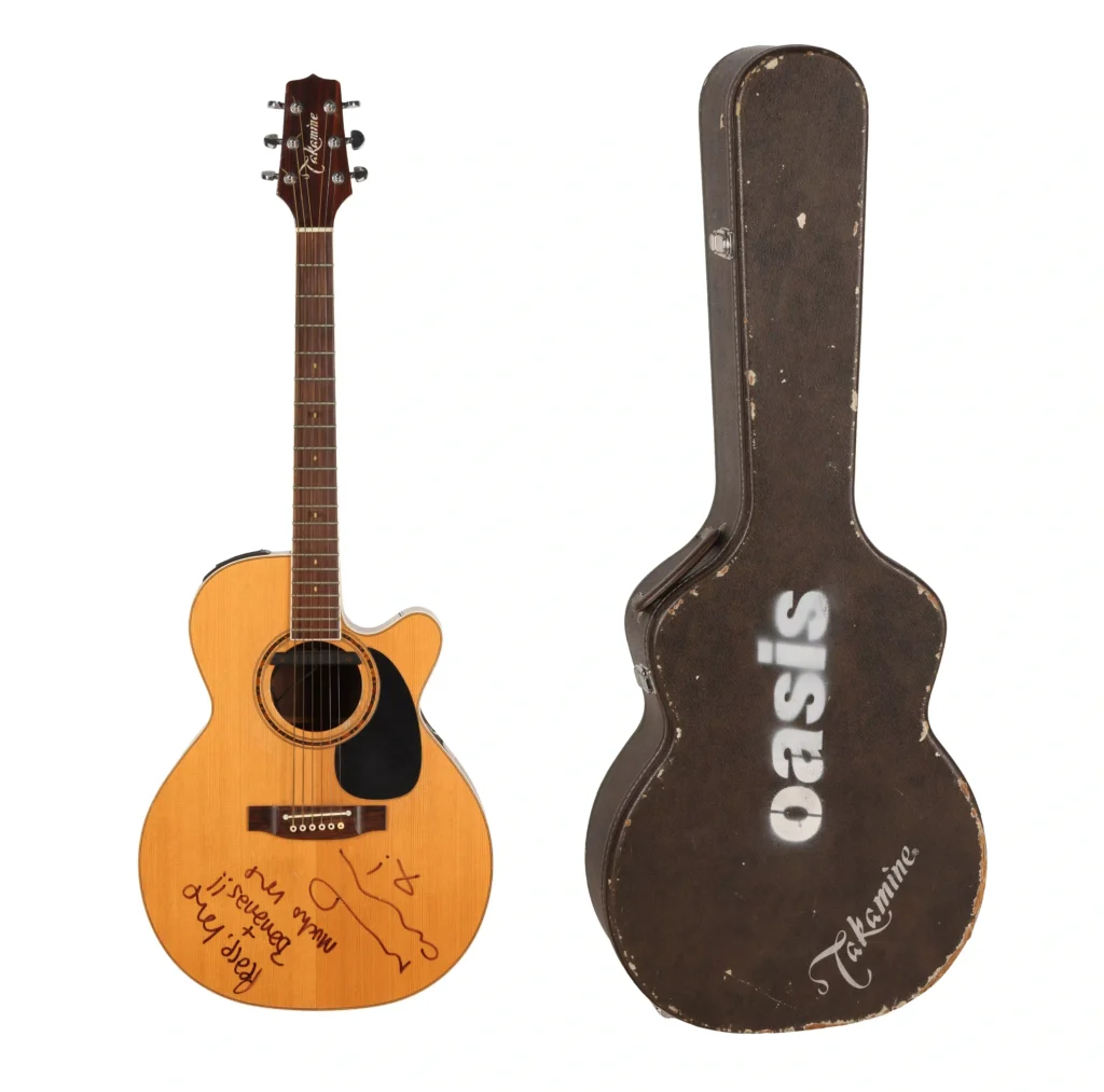 Noel Gallagher's guitar from Oasis's iconic 1996 MTV Unplugged performance has sold for a world record £226,800 at auction - and it was signed 'peace, love and bananas'.