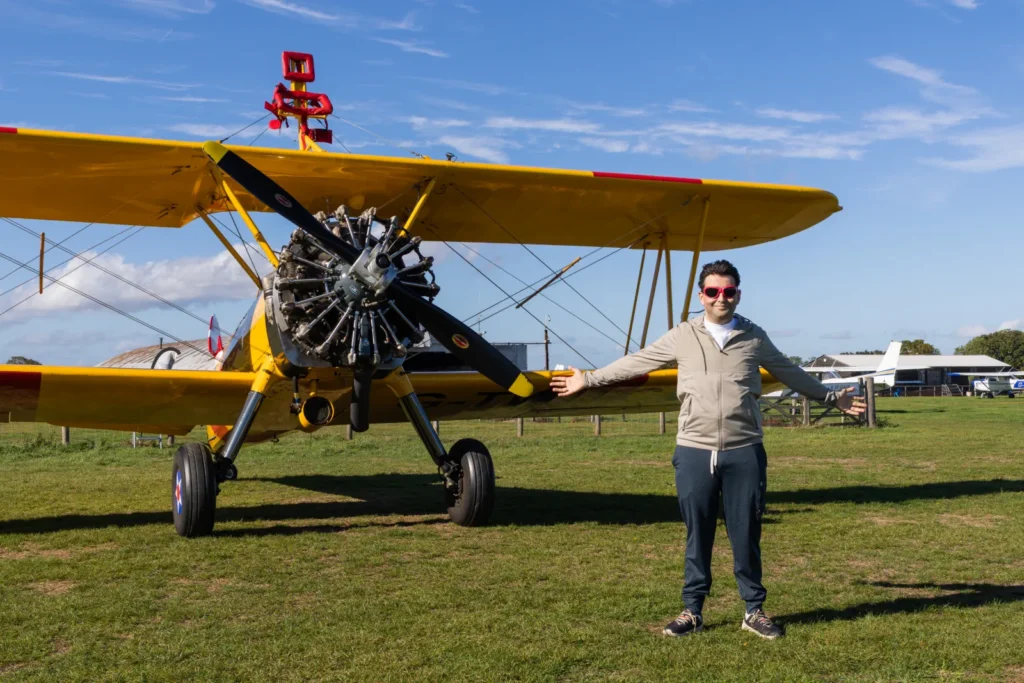 A daredevil collector has set a bizarre world record by opening £7,000 worth of trading card packs while strapped to the wing of a flying plane at speeds of up to 120mph.