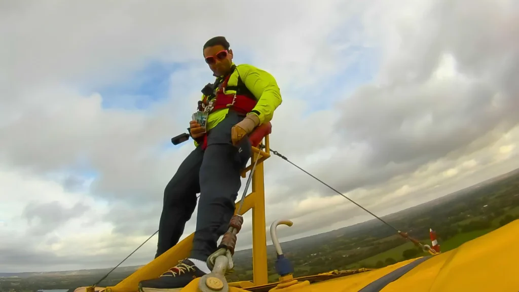 A daredevil collector has set a bizarre world record by opening £7,000 worth of trading card packs while strapped to the wing of a flying plane at speeds of up to 120mph.