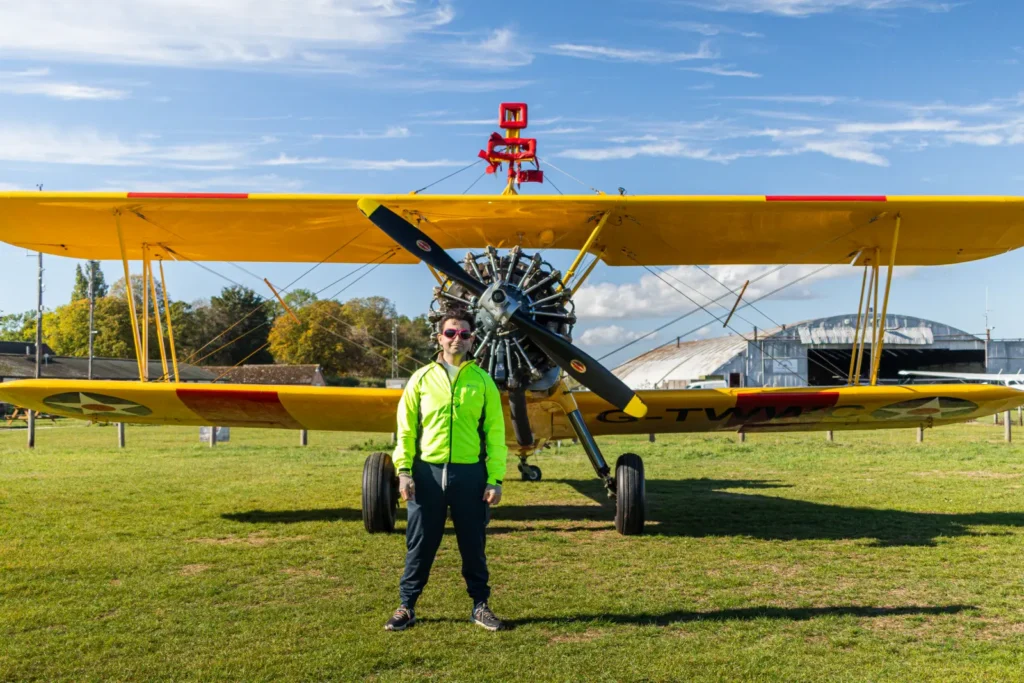 A daredevil collector has set a bizarre world record by opening £7,000 worth of trading card packs while strapped to the wing of a flying plane at speeds of up to 120mph.
