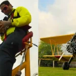 A daredevil collector has set a bizarre world record by opening £7,000 worth of trading card packs while strapped to the wing of a flying plane at speeds of up to 120mph.