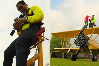 A daredevil collector has set a bizarre world record by opening £7,000 worth of trading card packs while strapped to the wing of a flying plane at speeds of up to 120mph.