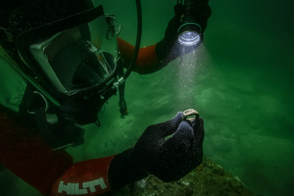Divers discover a rare 2,000-year-old bronze ring depicting the Lighthouse of Alexandria, one of the Seven Wonders of the Ancient World, in Cleopatra's sunken palace.