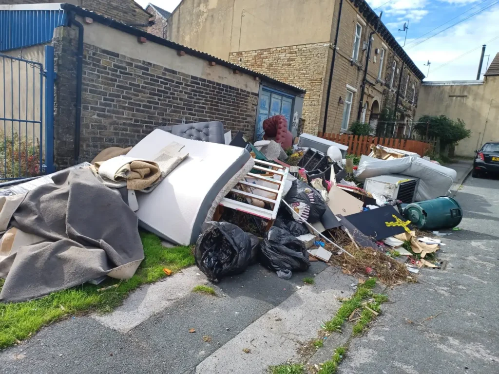 Brit residents have been left fuming as an ‘eyesore’ mountain of rubbish has been dumped on their street. Mattresses, sofas and household appliances were left strewn.