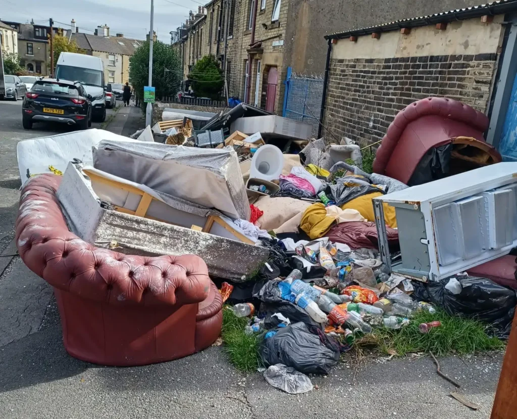 Brit residents have been left fuming as an ‘eyesore’ mountain of rubbish has been dumped on their street. Mattresses, sofas and household appliances were left strewn.