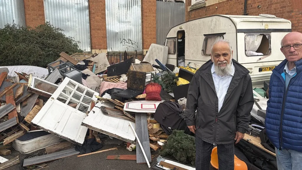 A caravan and mounds of fly-tipped rubbish have sparked fury after spilling onto a quiet Gloucester street near an abandoned school. Residents demand action.