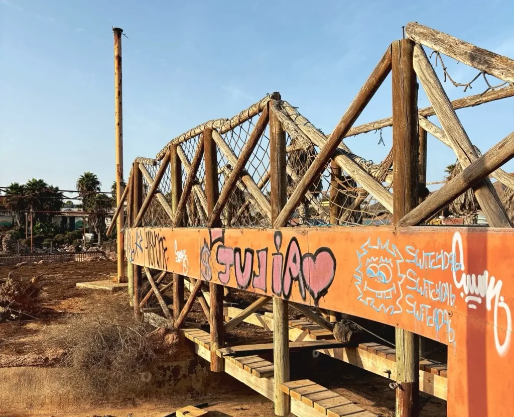 Eerie pictures reveal a former Spanish holiday attraction where sharks once swam, but now a giant graffiti-covered predator overlooks the decaying complex.