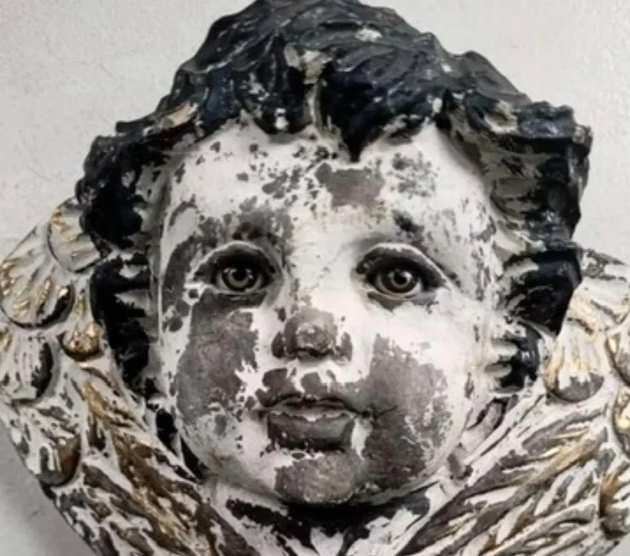 Sculptured white and grey angel head with halo made from foil or similar material