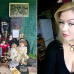 Blonde woman in black beside collection of antique dolls and paranormal objects on display