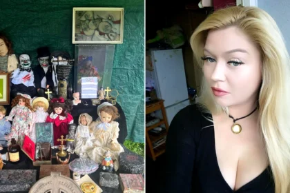 Blonde woman in black beside collection of antique dolls and paranormal objects on display